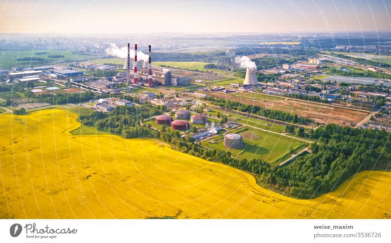 aerial view of power plant with flowering colza field nuclear station industry cooling atomic rapeseed canola tower energy spring drone cooler construction