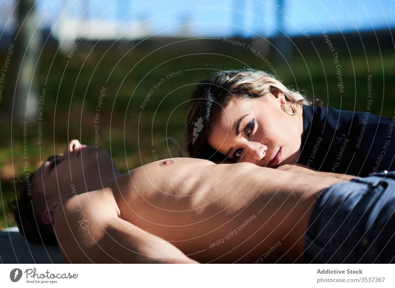 Calm couple having rest in park sensual relax lean naked torso together tender peaceful gentle lying calm attractive romantic blouse lifestyle outdoors young