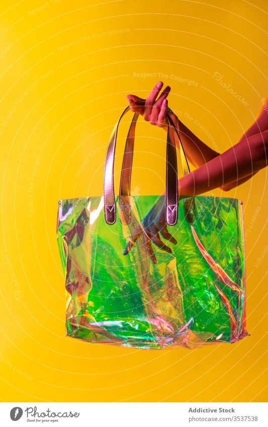 Crop woman with stylish plastic handbag style transparent creative colorful fashion accessory female concept vibrant fancy art trendy bright vivid material