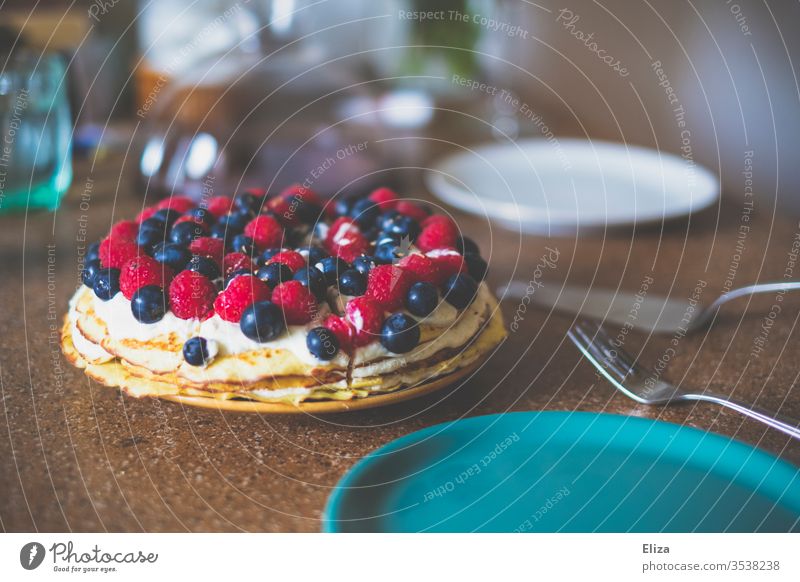 A cake or pie with raspberries and blueberries on a laid table piece of cake Cake eat cake Table Mint embellish Cream affectionately Delicious Berries Dessert