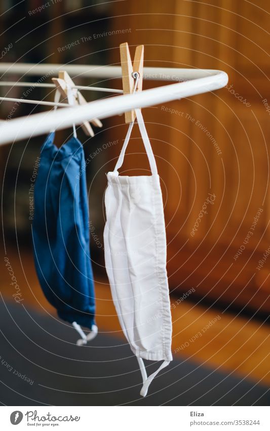Two face masks hang on the clothes drying rack after washing fabric mask Face mask Wash 60 degrees Mask Cloth Community mask Blue Cotheshorse Washer