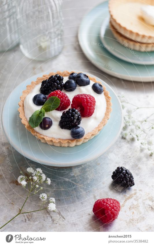 Tartlet with berries on a small turquoise plate Berries baked Dessert Baking Colour photo Baked goods Food photograph Blueberry Raspberry Cake Delicious