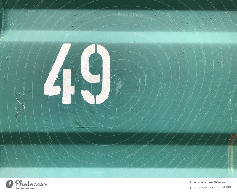 Number 49 - white number on the wall of a green container Digits and numbers Numbers and numbers Signs and labeling Container White container wall metal wall