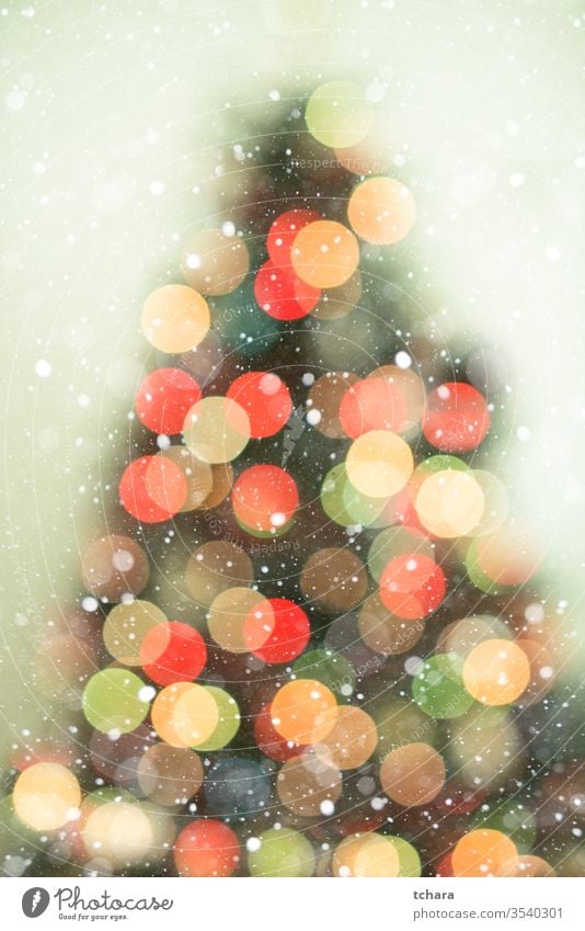 Christmas tree background with snowfall and bokeh lights decorate festive vibrant illumination vivid magic beauty celebrate shapes ornament smooth glittering