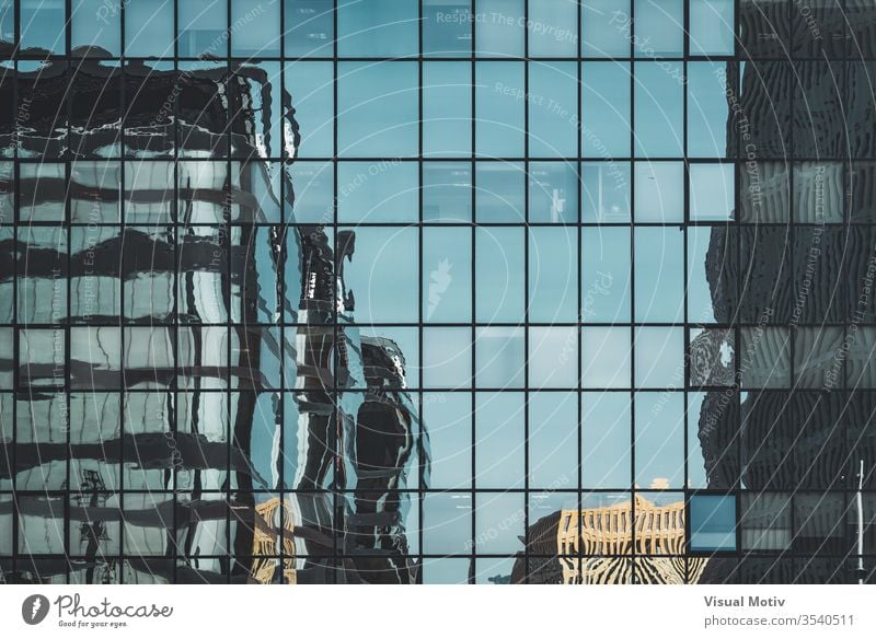 Office buildings reflected over an urban glass facade abstract abstract photography afternoon architectonic architectural architecture building design