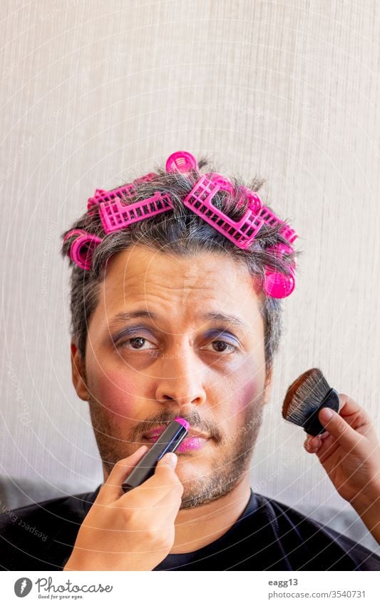Handsome father is being makeup by the hands of his daughters affectionate bonding brush carefree colors connection cosmetic crazy creativity dad daddy