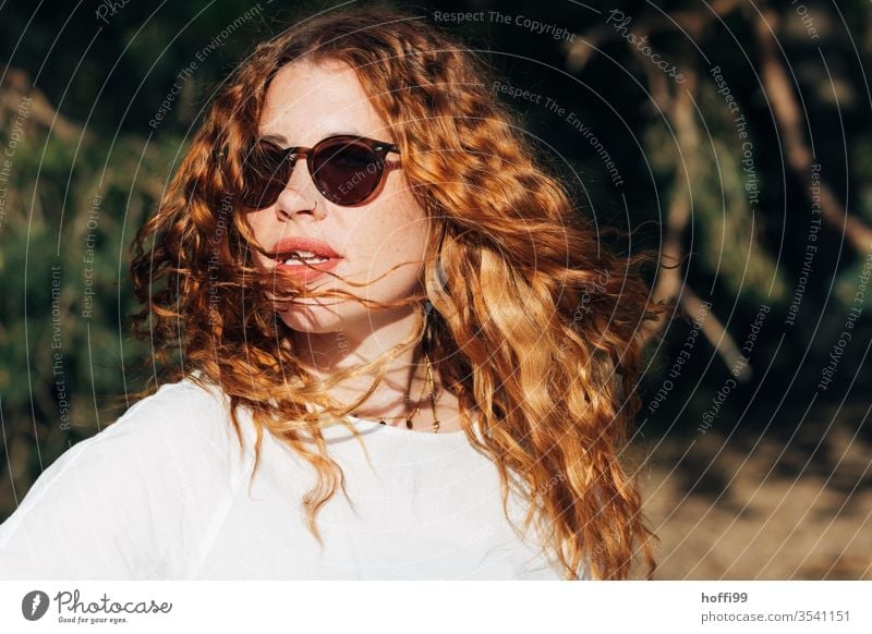 young woman with sunglasses and red curly hair turns towards the sun red hair red lips Curl Red-haired Woman already portrait Face Lips Lady Easygoing