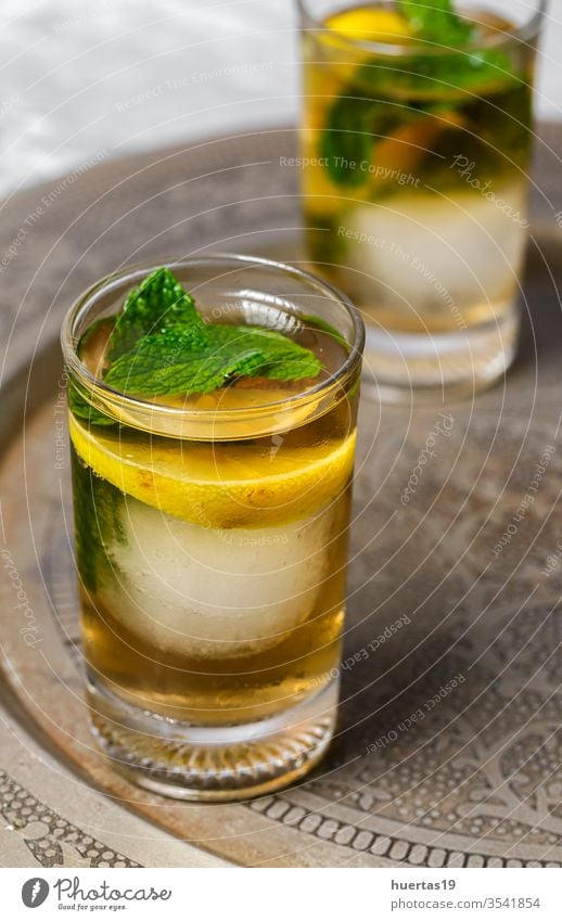 Refreshing glasses of tea with ice, mint and lemon wedges cold drink iced refreshment sweet cube cool liquid background beverage summer food healthy green