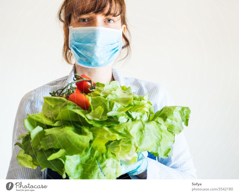 Woman in blue in face mask with fresh produce food delivery grocery store farm shop owner necessities hands safe staples girl foodstuff gloves holding online