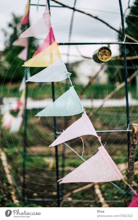 A colourful pennant chain as decoration in the garden Decoration Garden variegated cloudy Gray prettify embellish dreariness Feasts & Celebrations