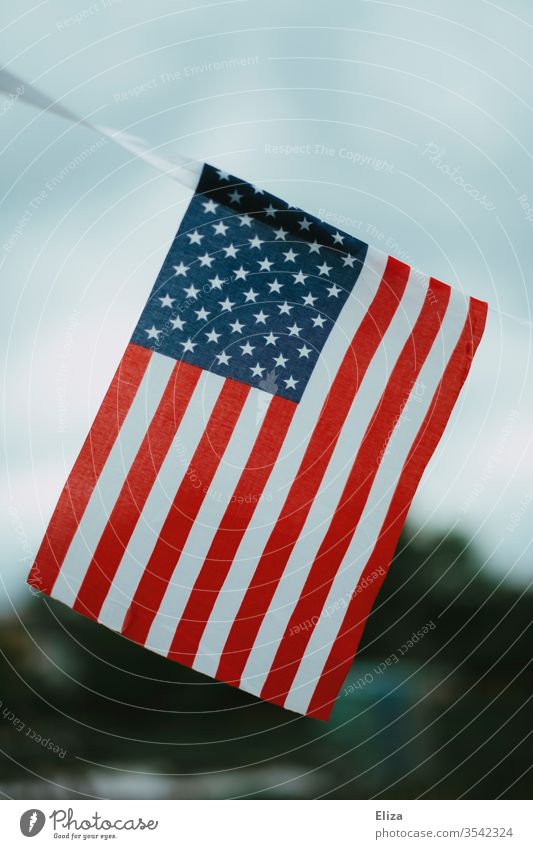The US flag outside the sky USA Ensign American Flag Americas trump nation patriotically National Patriotism Blow Sky cloudy blurriness Stripe