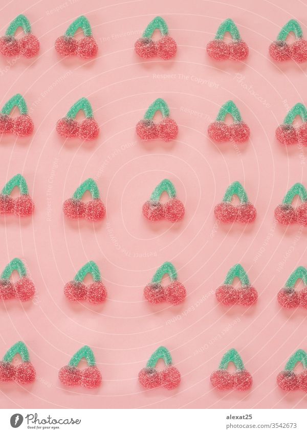 Jelly candies cherries pattern on pink background above assorted birthday bright candy cherry closeup color colored colorful concept confection creative