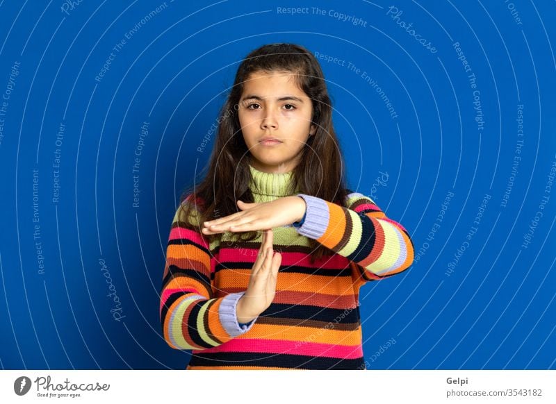Preteen girl with striped jersey preteen blue orange stop rest truce sign break hand time-out down time female people person pretty attractive background