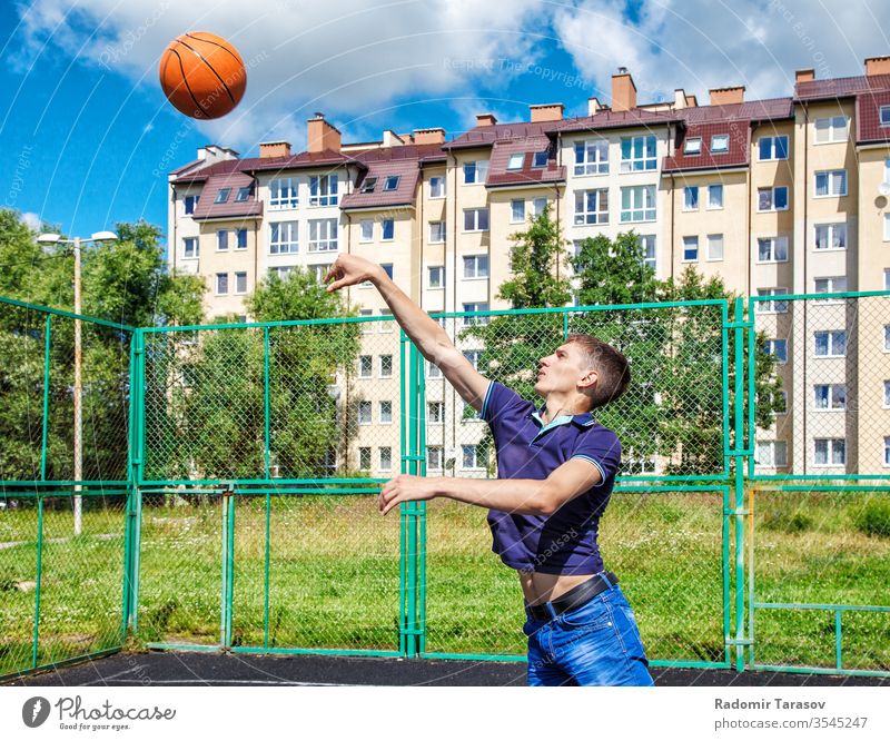 young man is training in a basketball game on the playground on a sunny summer day sport active athlete player fit court lifestyle healthy action athletic
