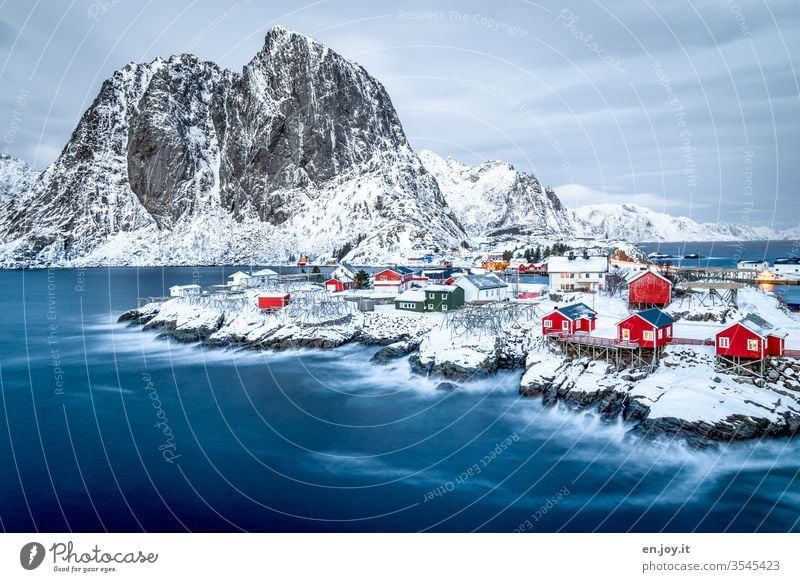 Hamnoy on the Lofoten with a view of the small red houses standing on snowy rocks at the blue hour Lofotes Norway Scandinavia Hamnøy Rorbuer Fishermans hut