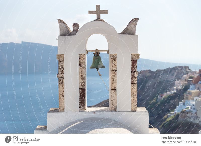 Bell tower with view on cliffs, ocean and village of Oia, Santorini, Greece santorini bell tower mediterranean island white oia blue greek church greece travel