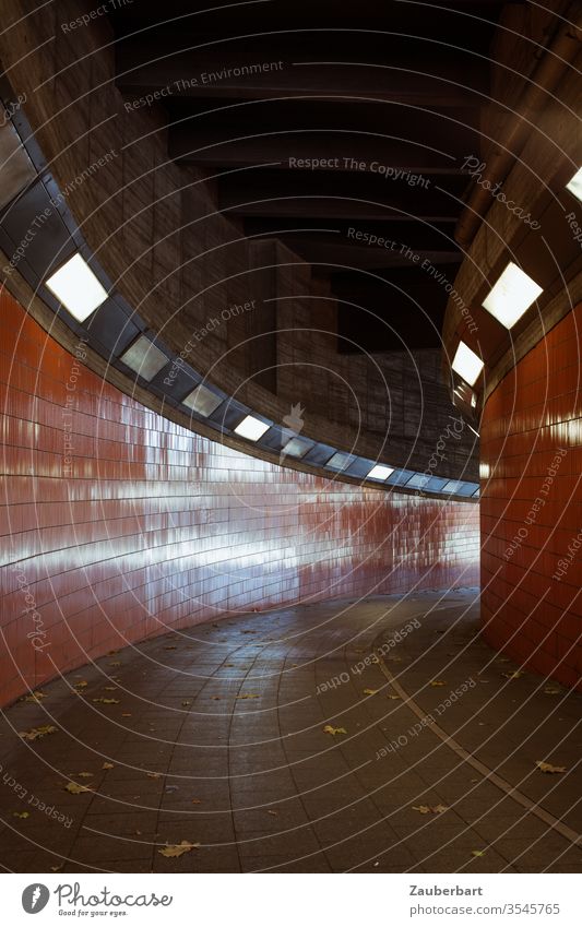 Tunnel with orange tiles in right-hand bend with light reflections Orange Light Reflex lamps Curve End Downward mirror Concern Fear Fear of the future Berlin