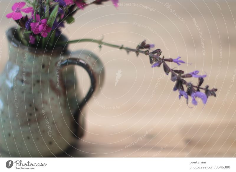 Still life lilac flowers in a vase on the table Stock Photo by