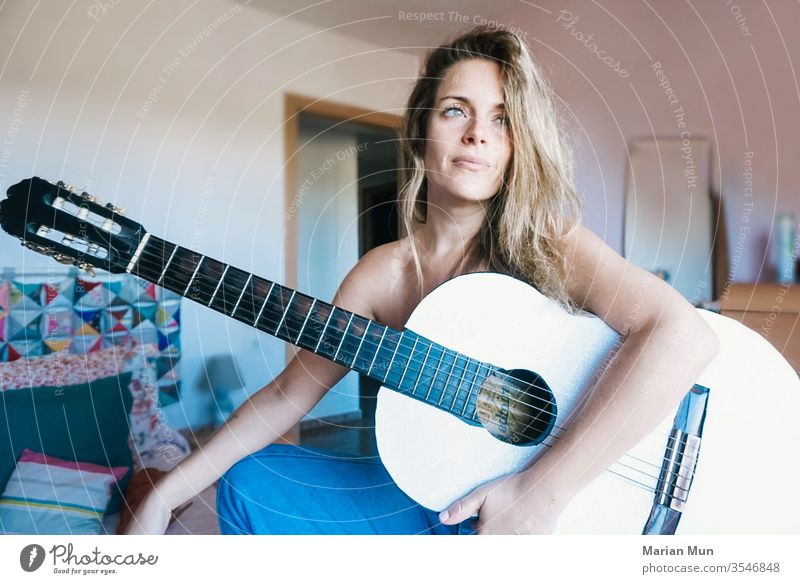 blonde girl with a guitar music looking lifestyle beauty sitting