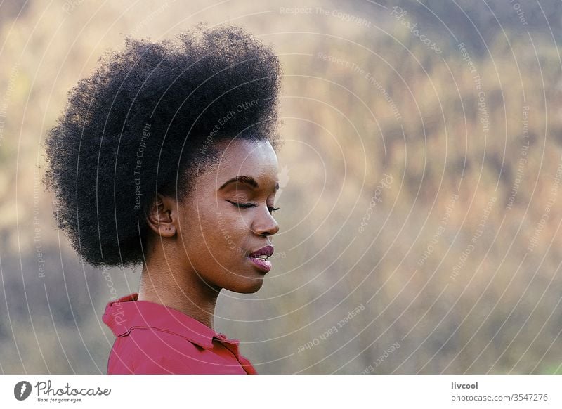 beautiful woman with afro hair meditating in nature black woman girl beauty pretty cool fashion style young people portrait lovely lifestyle garden closed eyes