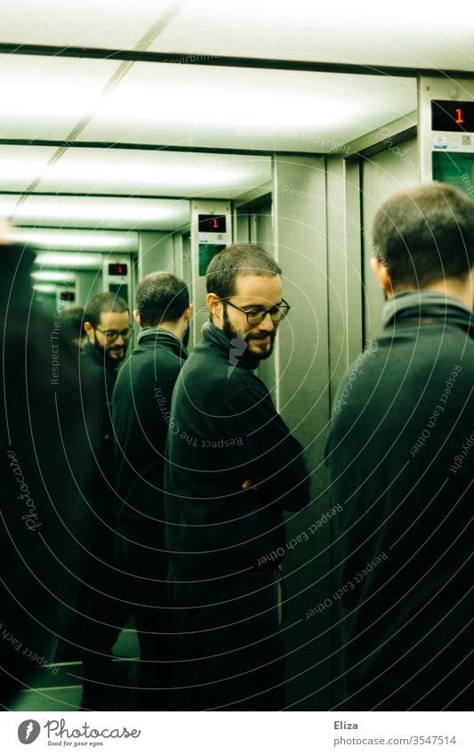 A man who is reflected several times in the mirrors of an elevator Man Eyeglasses Mirror reflection Personalities Multiple Personality infinitely Earnest