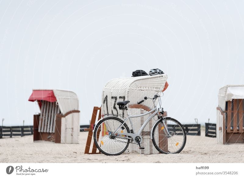 wicker beach chair, two helmets a bicycle by the sea Bicycle Helmet Ocean Beach Coast North Sea Baltic Sea Sand Sun Tourism Relaxation Island Sky