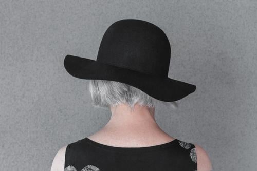 Gray-haired lady wearing black hat head neck gray grey gray-haired person woman female 50s 60s back fashion fashionable dress elegant style stylish senior age