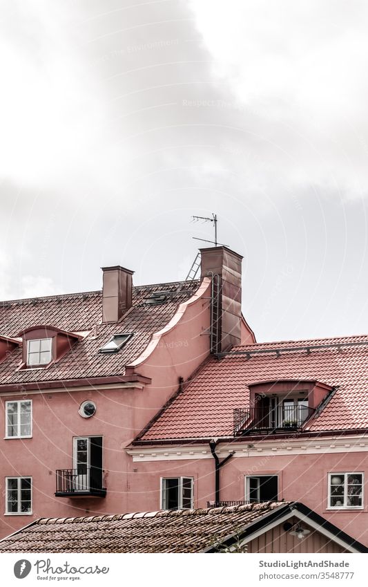 Tiled rooftops of pink European buildings roofs tile tiled house houses home homes windows outdoor exterior chimney wall Stockholm Sweden Swedish Scandinavia