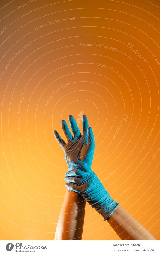 Crop doctor in medical gloves touching injured wrist gesture surgical disposable physician sign arms raised coronavirus covid 19 latex gesticulate symbol