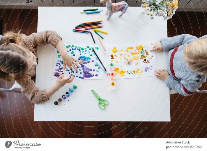 Preschool brother and sister painting together at home children draw creative play preschool studio living room gouache colorful blond little drawing kid light