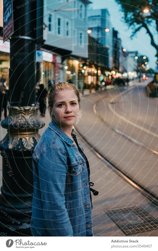 Young woman in middle of Istanbul busy street city walk urban district road young building serious noise blond exterior jeans female outfit outdoors twilight