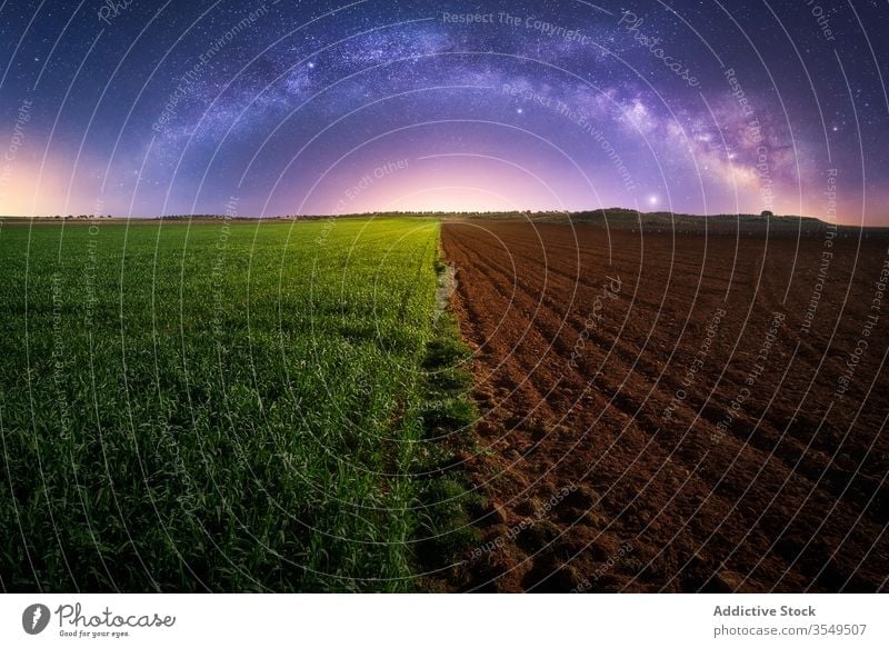 Agricultural green and plowed field agriculture half night milky way plant soil twilight landscape rural countryside galaxy starry farm magnificent farmland