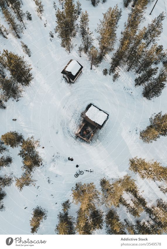 Small houses in winter forest lumberjack aerial snow countryside landscape nature cold finland tree pine rovaniemi travel tourism season rural white building