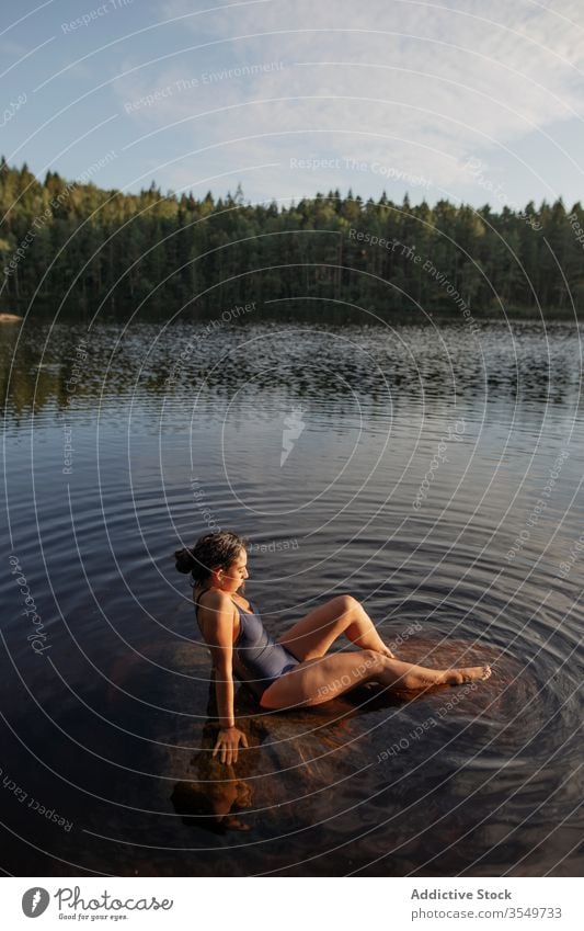 Woman in swimsuit sitting in lake woman water calm sunset enjoy summer majestic scenery female forest landscape tranquil serene harmony peaceful idyllic wood