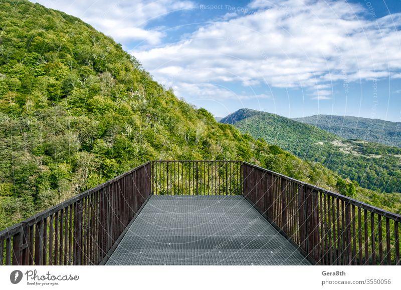 observation deck in canyon in Georgia Batumi Caucasus autumn blue branches bridge bright cliff climate clouds color construction day forest green hanging high