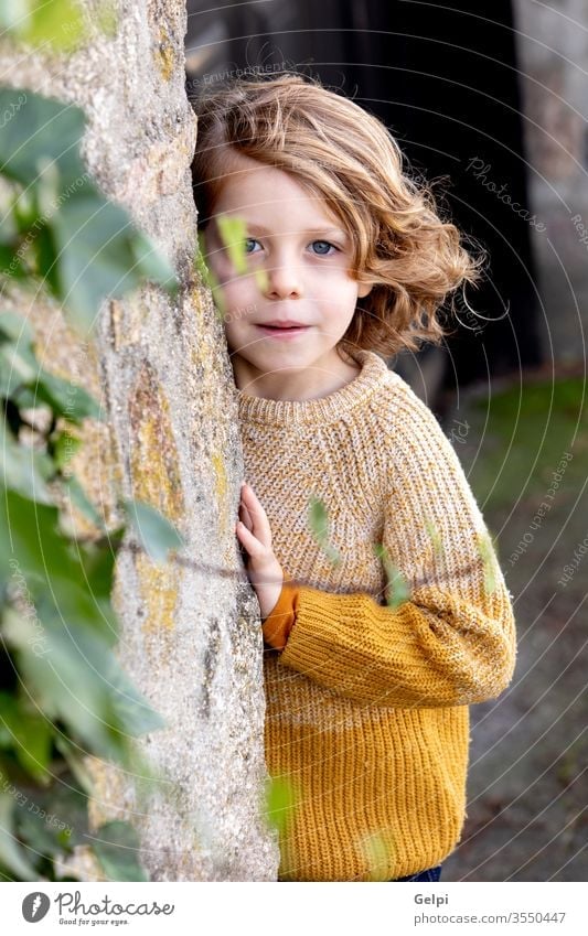 Portrait of cute caucasian blondie baby boy with fishing rod in