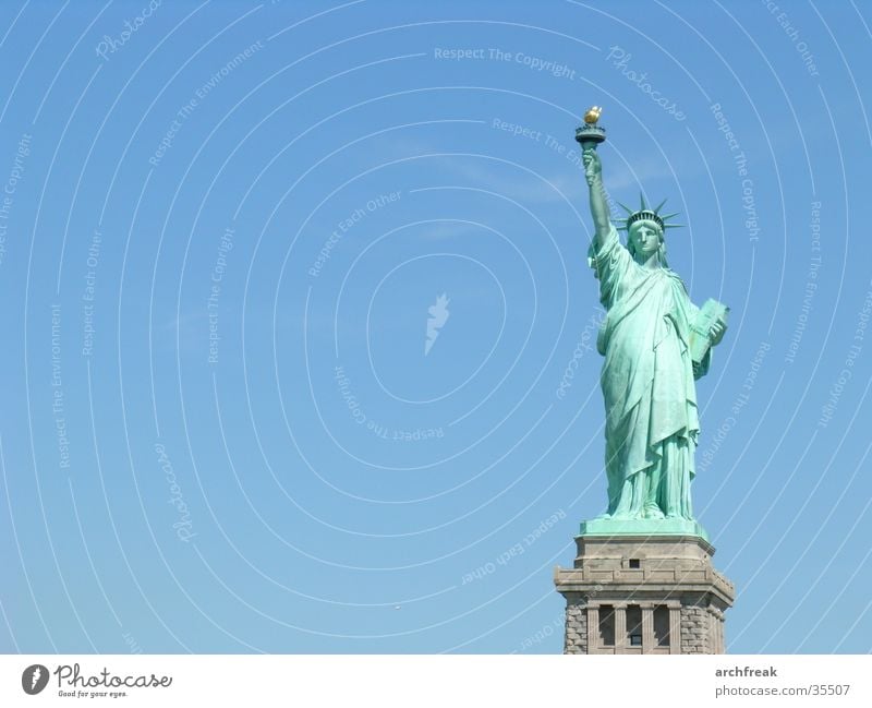 Statue of Liberty New York City Fairness Freedom Democratic Ellis Island USA Monumental Symbolism Isolated Image Copy Space left Blue sky Clear sky