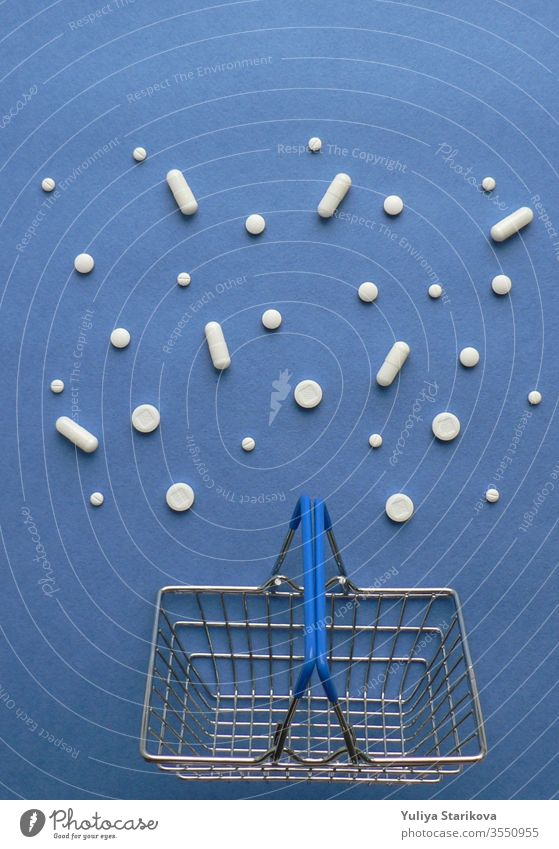 Shopping cart with medicine pills in pack on classic blue background with copy space. Treatment and of hope for recovery. Creative idea for drugstore, online pharmacy, health lifestyle and pharmaceutical company business concept.