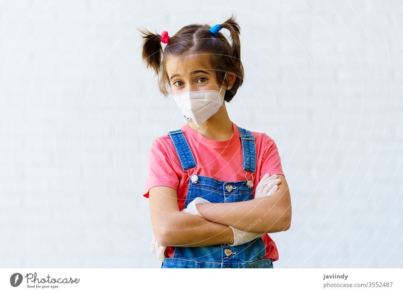 Child girl wearing a protection mask against coronavirus during Covid-19 pandemic kn95 covid-19 caucasian children safety sick female ill illness outdoors young
