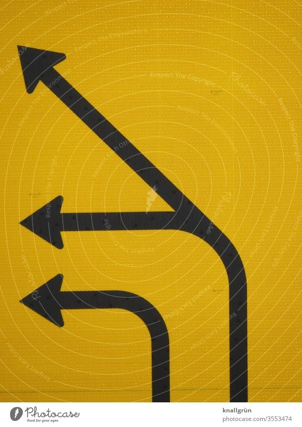Partial view of a traffic route, three black directional arrows, pointing to the left, on yellow background Signs and labeling Road sign Arrow direction arrow