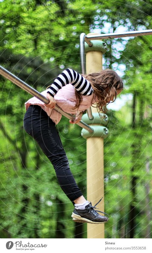 Girl on the gymnastics pole woodland playground Playground Child Coil Movement Gymnastics motor function Playing Nature free time Play instinct Infancy Joy