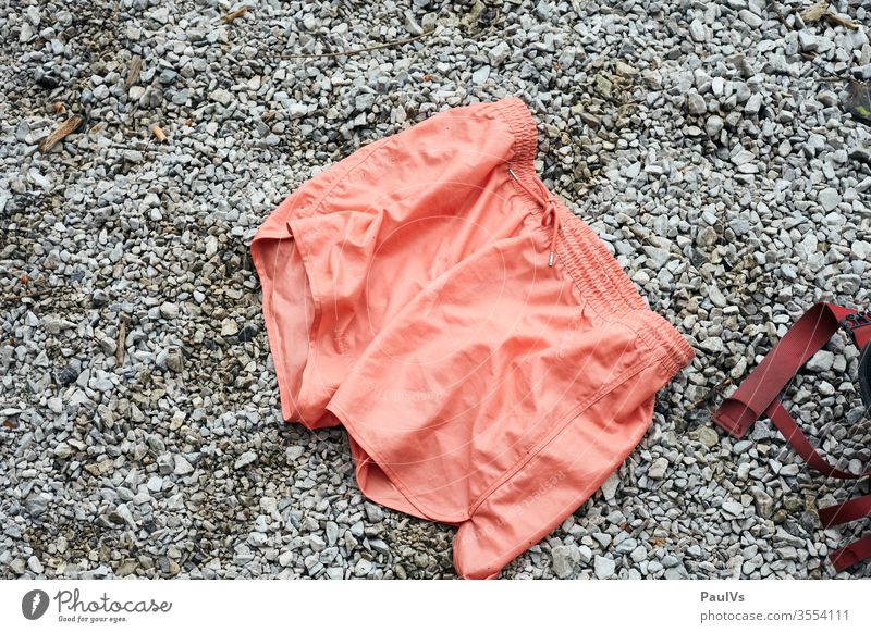 Bathing trunks is on the beach salmon-coloured Swimming trunks Beach Still Life Summer Pants Swimming & Bathing Tourism Summer vacation Exterior shot