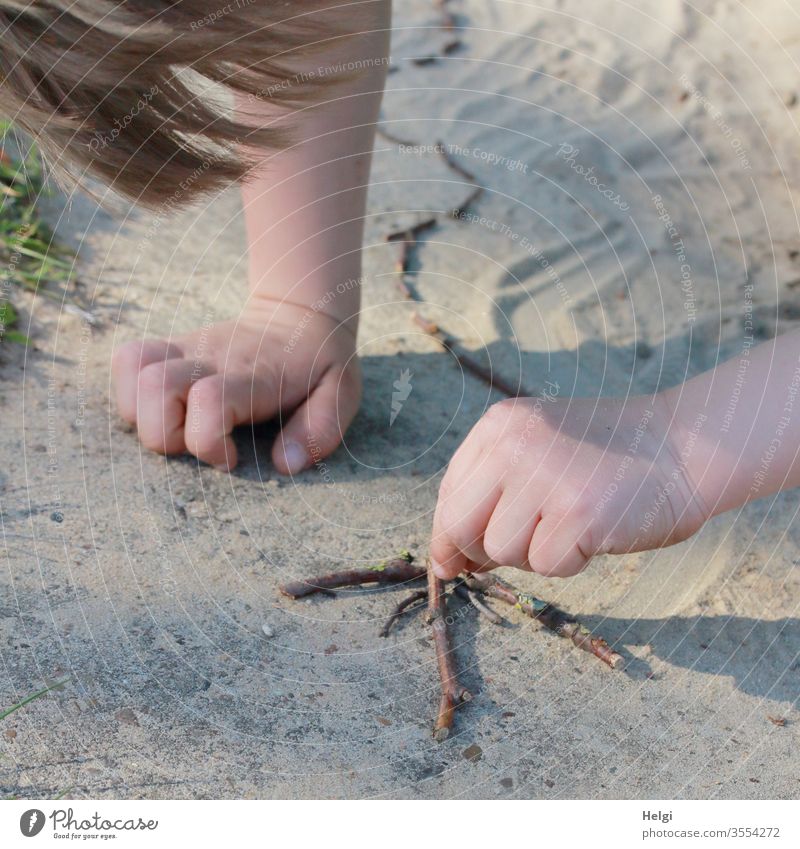Living out creativity - close-up, little boy lays an arrow made of sticks in the sand Child Infancy Boy (child) Toddler Human being arm Hand hair Detail Sand