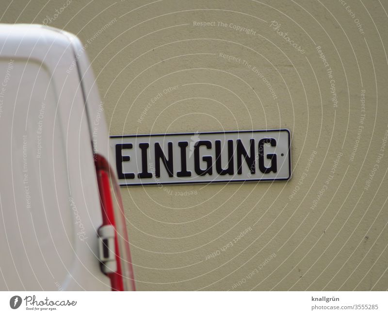 Sign with the word CLEANING, where the R is hidden by the rear of a van cleaning Signs and labeling Signage Characters Exterior shot Colour photo Subdued colour