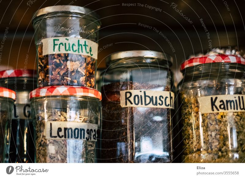 Labeled preserving jars with different kinds of loose tea Tea safekeeping Chamomile Roibush diverse varieties lemongrass Herb tea have tea Glass Jam jar Labels