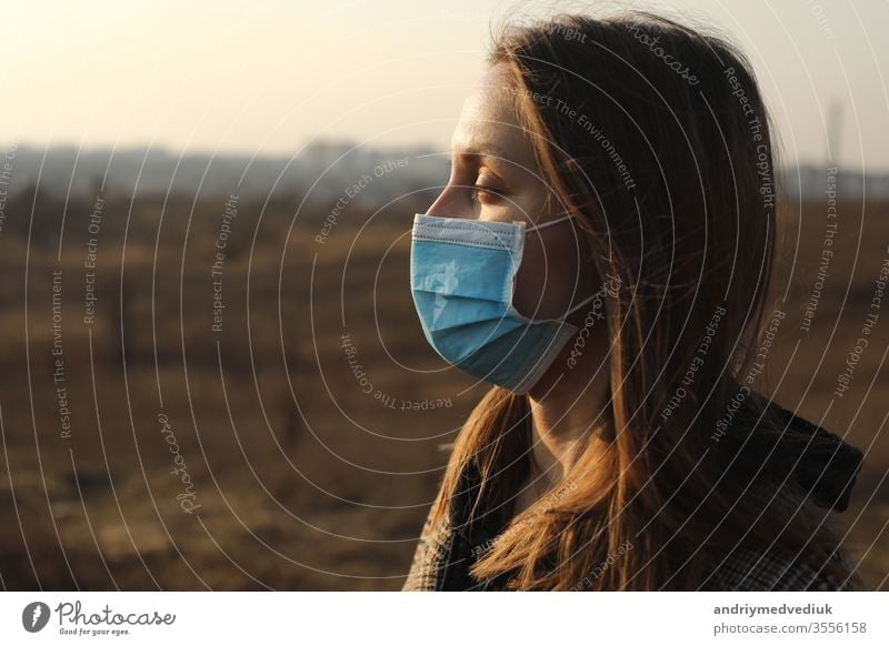 close up of Photo of a woman wearing protective mask against infectious diseases, coronavirus, covid-19 and flu outdoors. copy space. Coronavirus outbreak in Europe. Flu epidemic spread prevention