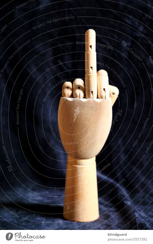 Symbol of provocation. Wooden hand for anatomical, artistic drawing, which raises a finger to demonstrate to those responsible the criticism of the handling of art and culture in the Corona crisis.