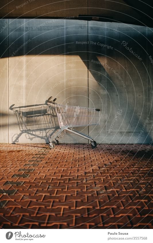 Empty shopping cart Shopping Shopping basket consumerism Economy Shopping Trolley Supermarket Consumption Metal Colour photo Deserted Basket Trade Exterior shot