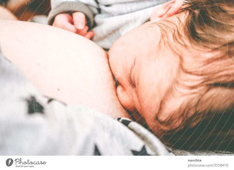 Close up of a young mother breastfeeding her little baby breast-feeding mom motherhood new born birth food eat eating head closeup close-up health healthy life