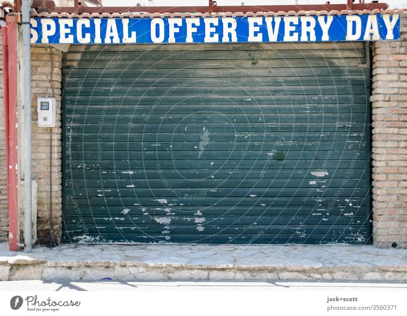 taken literally | Aha! special offer every day Souvenir shop Roller shutter English Typography upper-case letters Word Ravages of time Trade Change